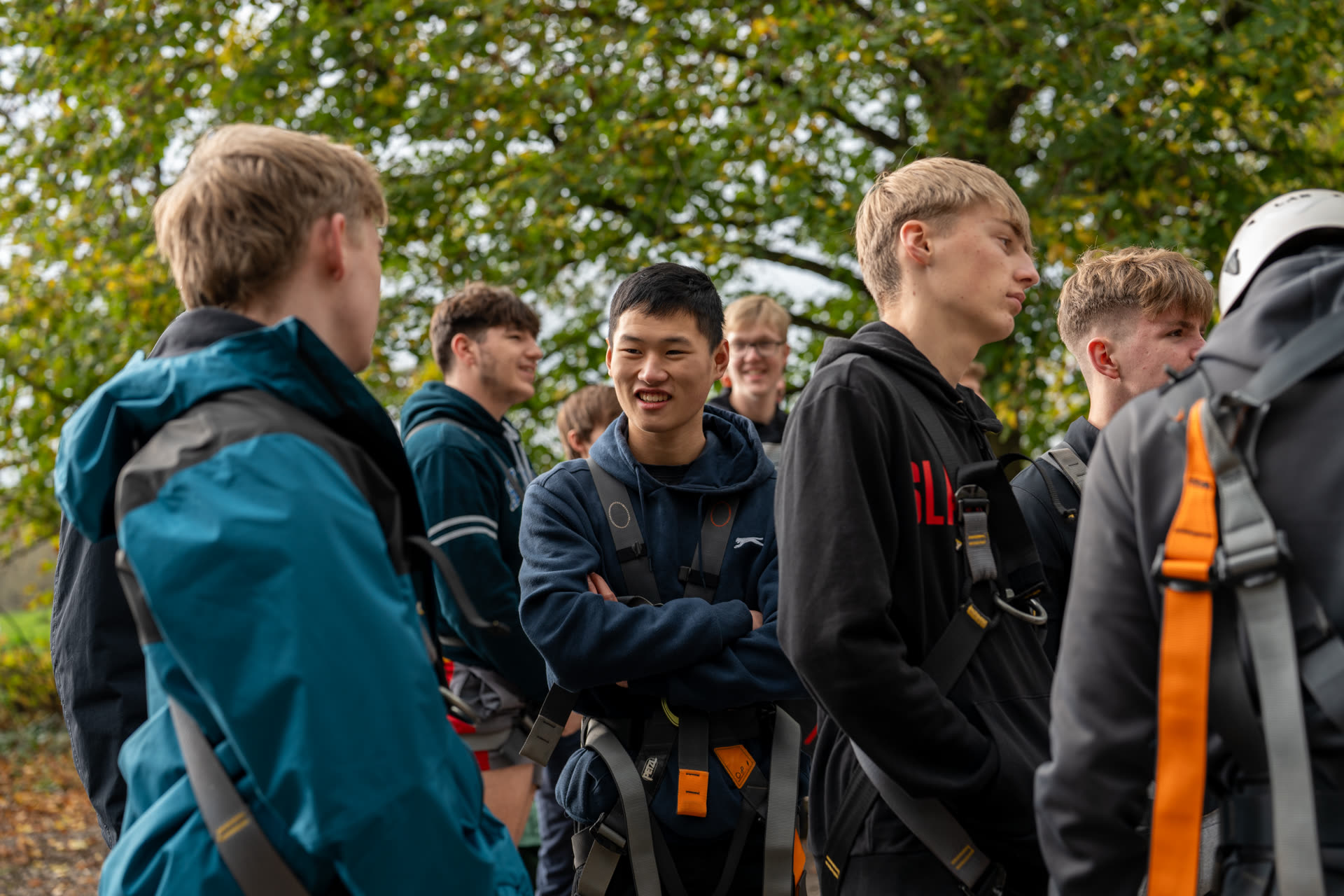 Several young men gathered in a circle, interacting and laughing, showcasing camaraderie and friendship.